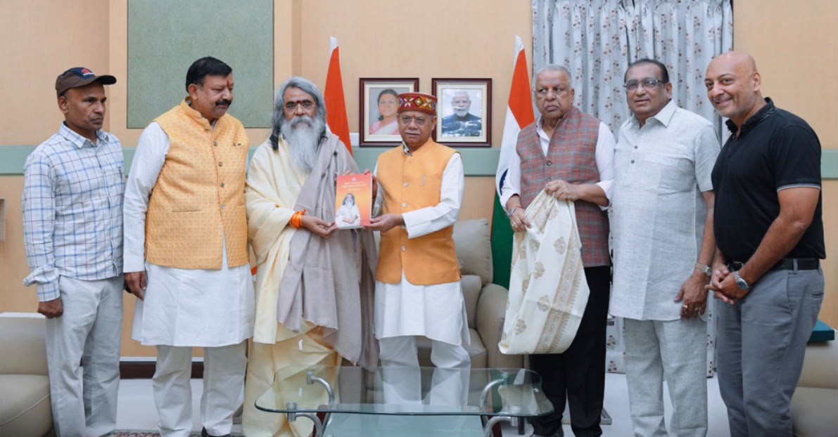 Maharishi Yogi Madhusudan Ji presenting his book to the Hon'ble Governor at Raj Bhavan, accompanied by a delegation